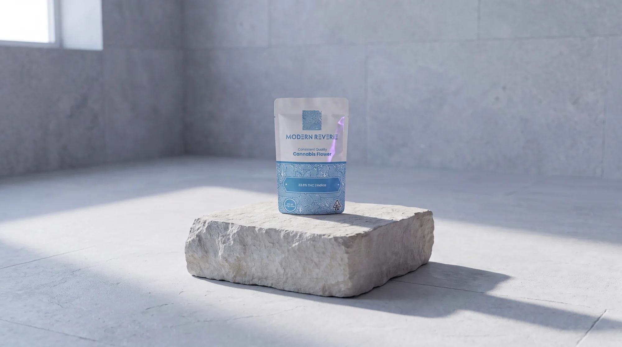 A Modern Reverie 3.5g flower pouch on a raw limestone block in a bare gallery room in cold daylight