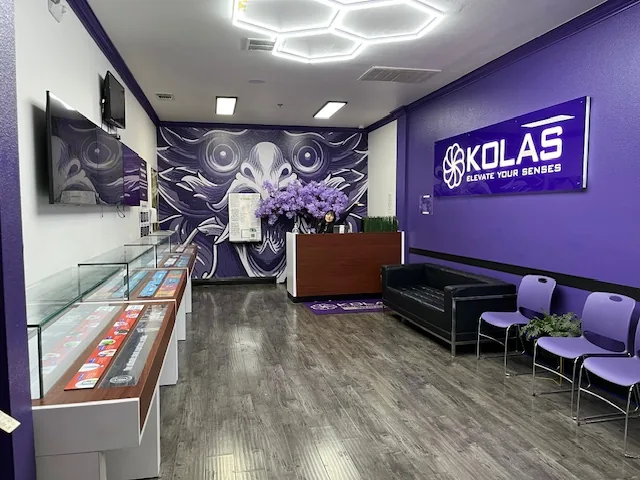 The Blumenfeld lobby: a purple wall with the KOLAS sign, hexagon ceiling lights, a mural and seating