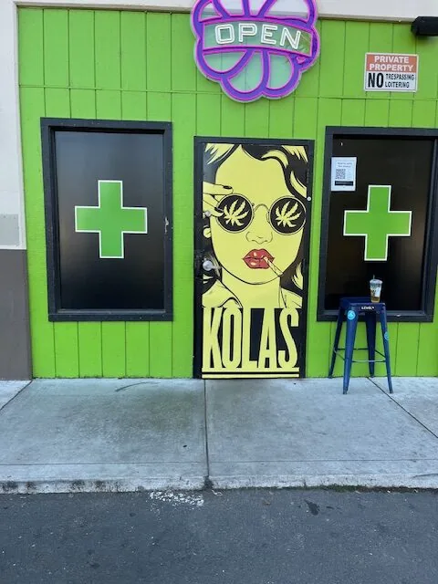 The KOLAS door mural beside a green cross window at KOLAS South Watt